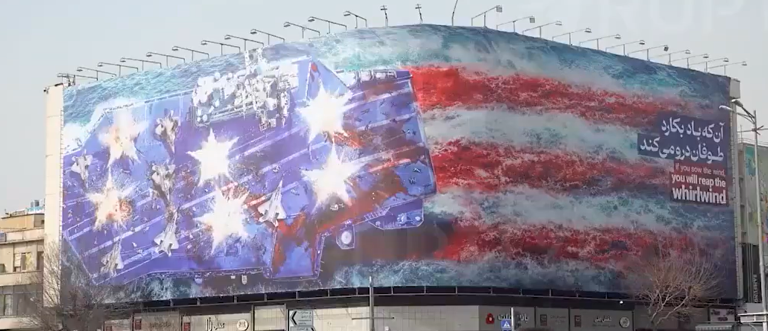 Crusoé: Irã exibe outdoor no centro de Teerã com porta-aviões americano destruído