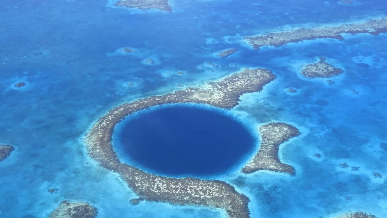 O buraco azul de 300 metros de largura que parece um portal no oceano e mergulha mais de 120 metros nas águas de Belize