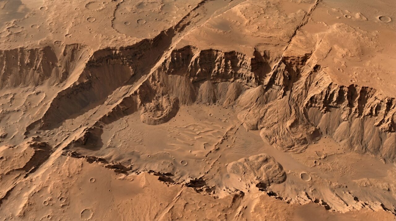 As paredes fraturadas e os blocos abatidos de Valles Marineris ajudam a mostrar que sua origem está no estiramento da crosta marciana e não em um único rio gigantesco