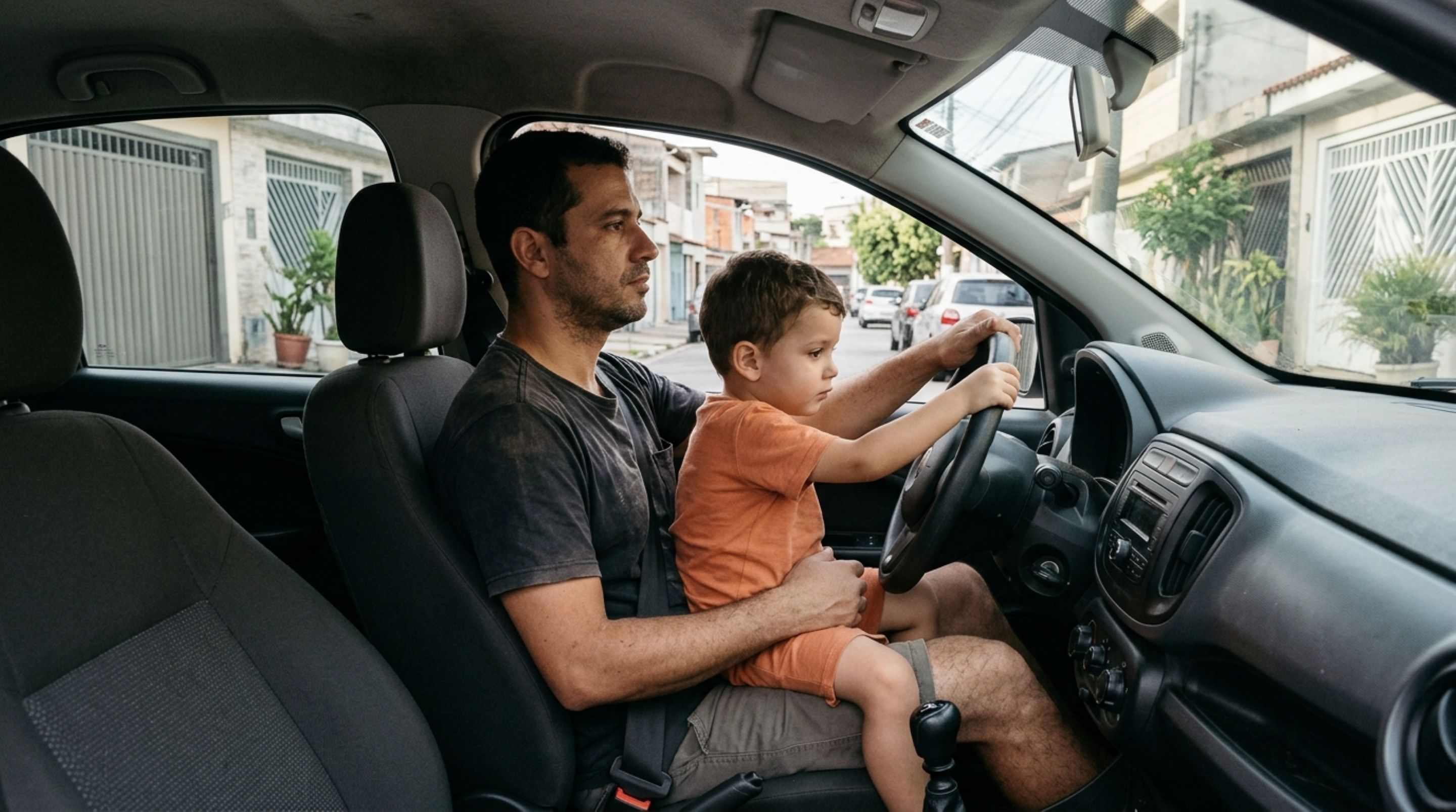 Pai deixa o filho pequeno sentar em seu colo para movimentar o carro por poucos metros na rua, acredita que a distância elimina o risco e descobre como funcionam as exigências de transporte infantil ao ser parado por agentes